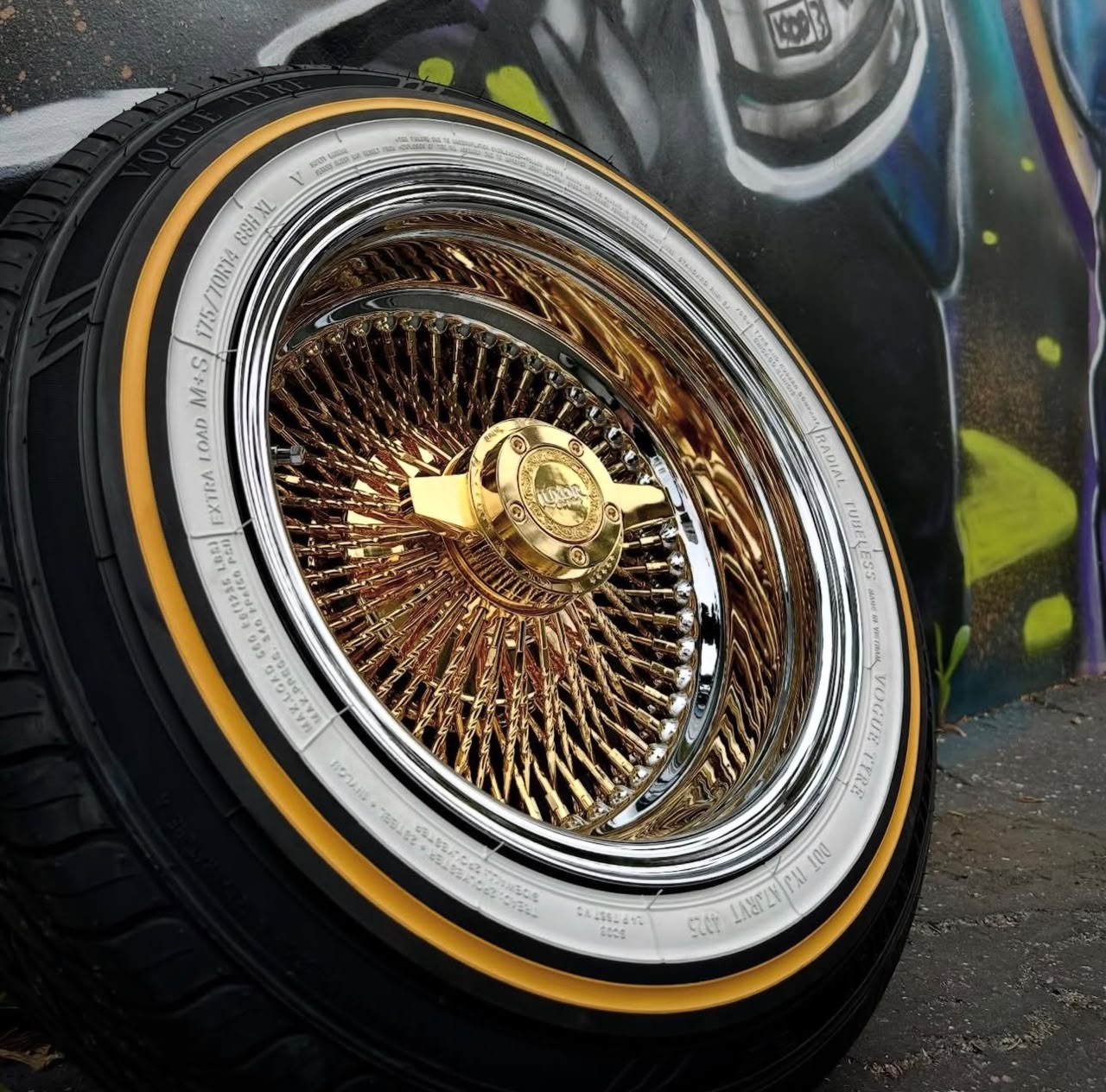 WhatsApp-Image-2026-08-01-at-14.23.41-1 13×7″ Pure 24K California Gold Center Wire Wheels 100 Spoke Reverse Straight Lace | Chrome Lip + 155/80R13 1.6″ True Whitewall Tires | Set of 4 - Image 1